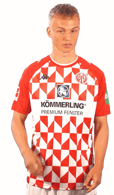 a man wearing a red and white shirt that says kommerling premium fenster on it