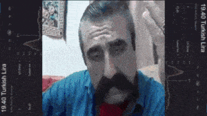 a man with a mustache and a blue shirt is shown on a phone screen