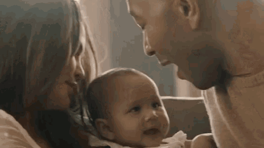 a man and a woman are holding a baby and the woman is saying `` i know it will kill me when it is over ''