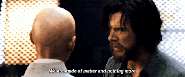 a bald man and a bearded man are looking at each other with the words we are made of matter and nothing more above them