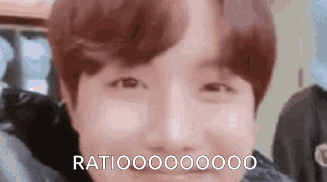 a close up of a person 's face with the words `` ratiooooooo '' written on it .
