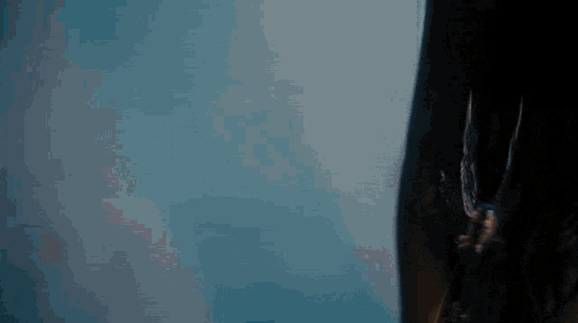 a close up of a person 's arm with a blue sky in the background