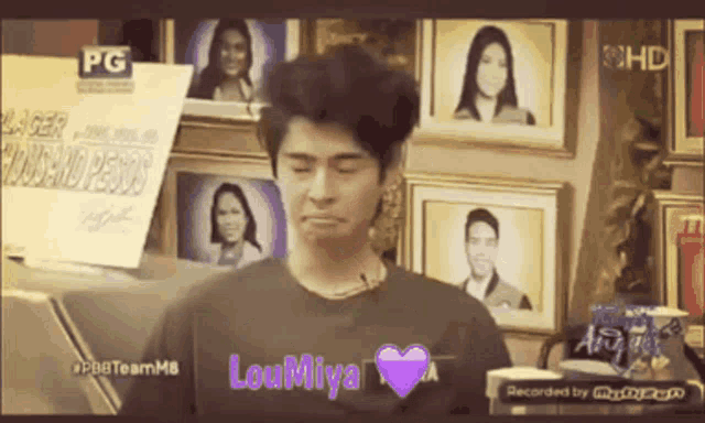 a man wearing a t-shirt that says loumiya