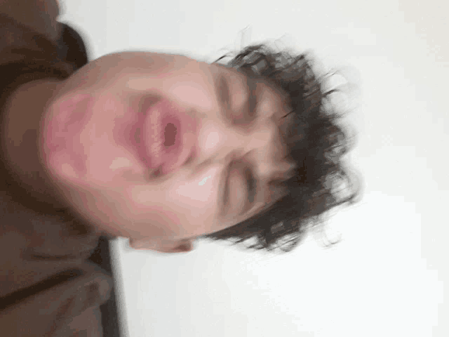 a close up of a person 's face with their eyes closed