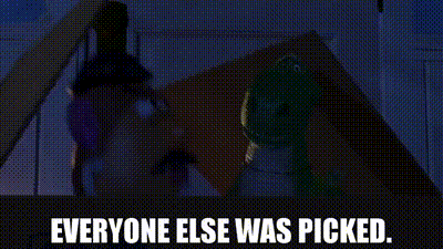 a person is standing in front of a door with the words `` everyone else was picked '' written on it .