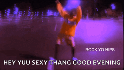 a man in an orange shirt is dancing in a purple light .