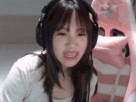 a woman wearing headphones and a white shirt is sitting in a pink chair .