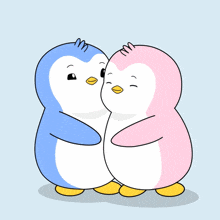 a couple of penguins hugging each other with a heart above them