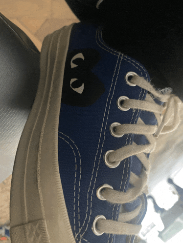 a blue shoe with a black heart on it