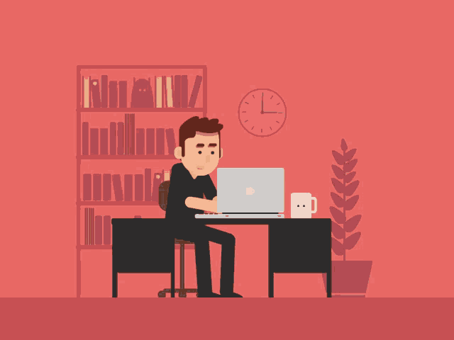 a man sits at a desk with a laptop and a clock on the wall behind him