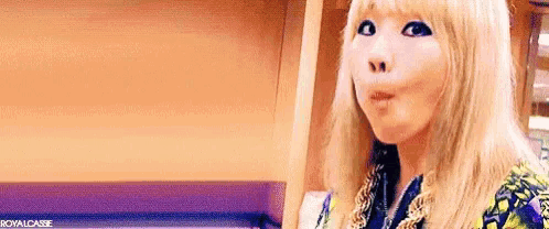 a woman with blonde hair is making a funny face and making a funny face .