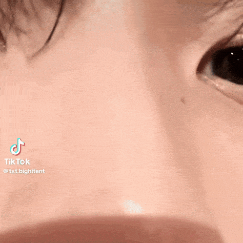 a close up of a person 's nose and eyes with a tik tok logo on the bottom .