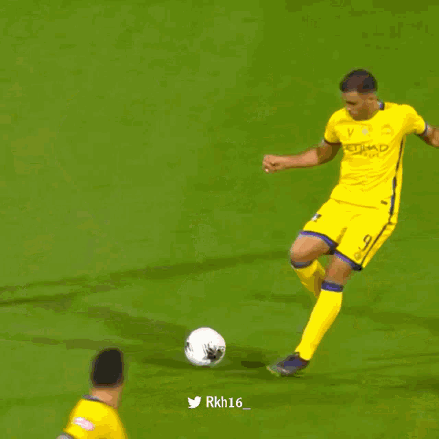 a soccer player wearing a red and blue jersey with the number 14 on it