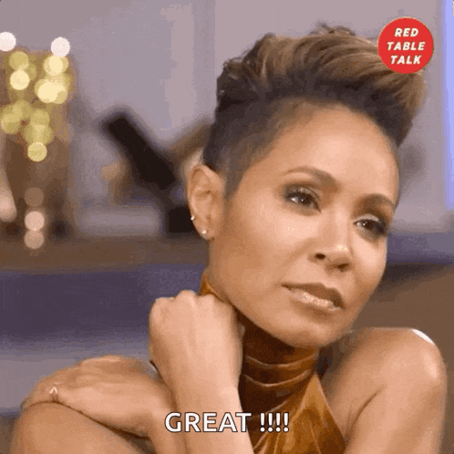 a woman with a shaved head says " great " in front of a red table talk logo