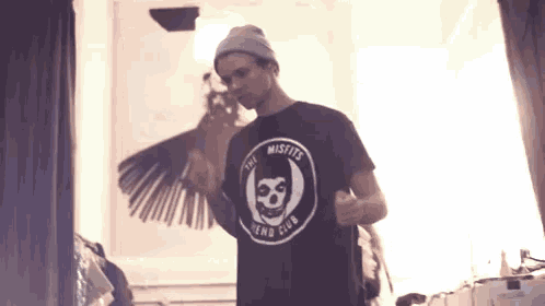 a man wearing a misfits dead club t-shirt