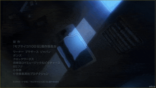 a person laying on a bed with a blue blanket and a light shining on them