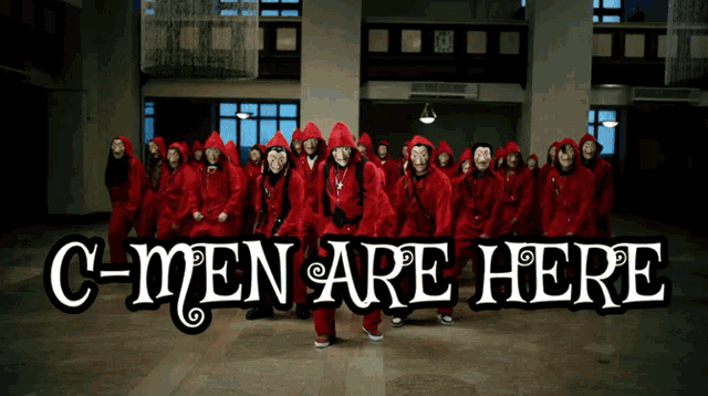 a group of people in red jumpsuits are standing in a hallway with the words c-men are here above them