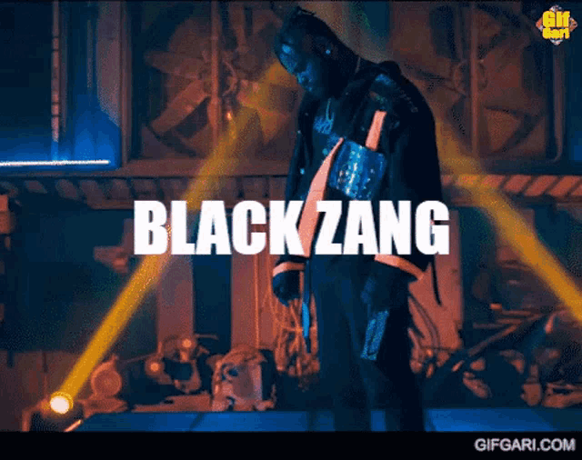 a man is standing on a stage with the words " black zang " written above him