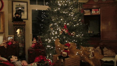 a living room decorated for christmas with a tree and a clock