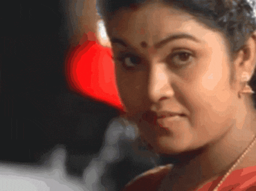 a close up of a woman 's face with a red heart behind her