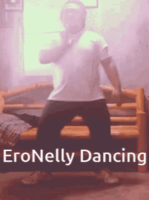 a man in a white shirt is dancing in front of a bed with the words " eronellsy dancing " on the bottom