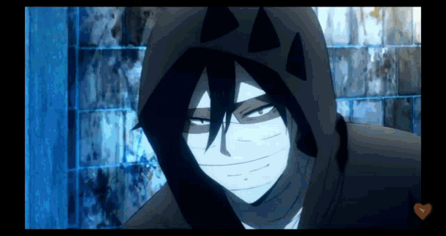 a close up of a person wearing a hooded jacket with triangles on it