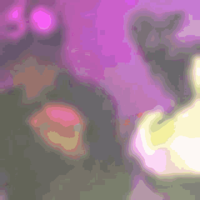 a blurry picture of a person standing in front of a purple wall with a purple background .