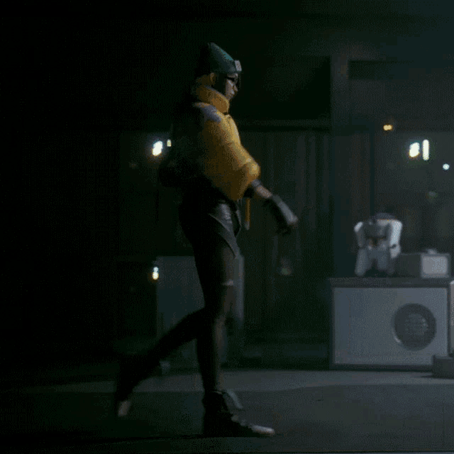 a person in a yellow jacket and black pants is walking