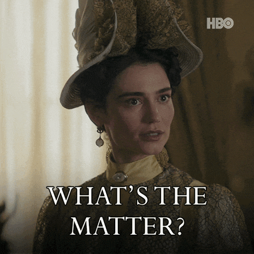 a woman is wearing a hat and earrings and says what 's the matter