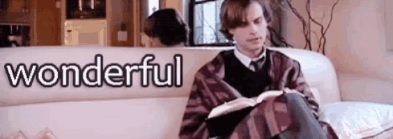 a man is sitting on a couch reading a book and the word wonderful is written on the bottom .