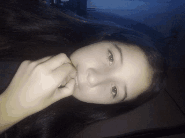a close up of a girl 's face with her mouth open