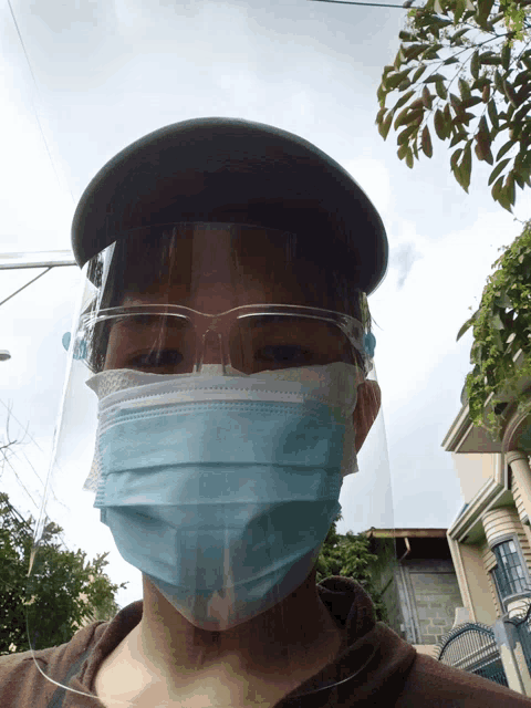 a person wearing a face mask and a visor