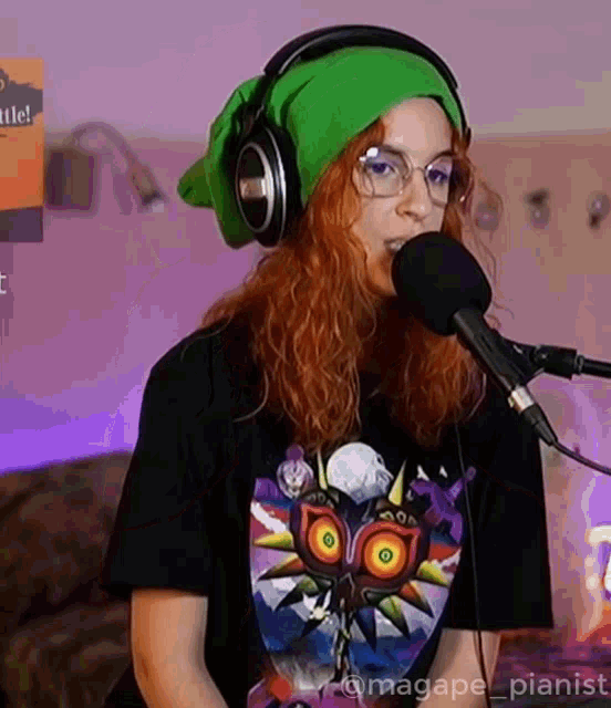 a woman wearing headphones is singing into a microphone