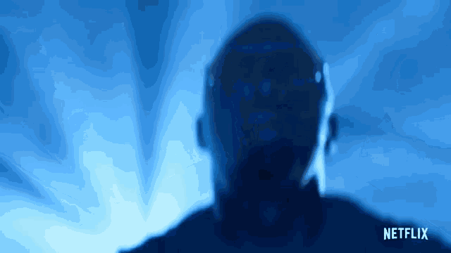 a man 's face is silhouetted against a blue background with netflix written in the corner