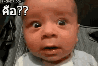 a baby with a surprised look on his face is sitting in a chair .