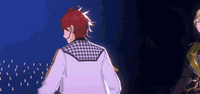 a man with red hair and a white jacket is standing in the dark .