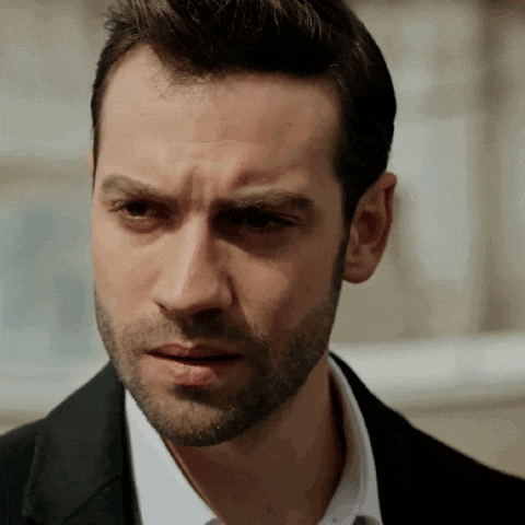 a man with a beard wearing a suit and white shirt