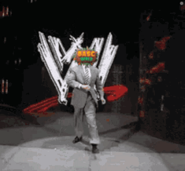 a man in a suit and tie is dancing on a stage with a wwe logo in the background