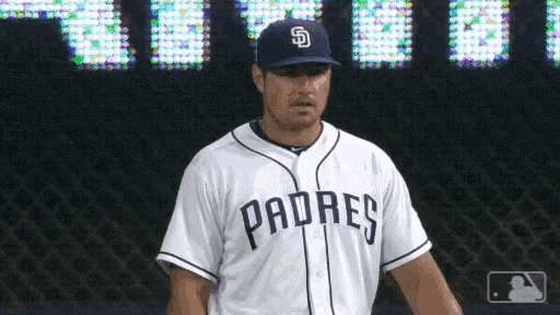a padres baseball player wearing a white jersey and a blue hat