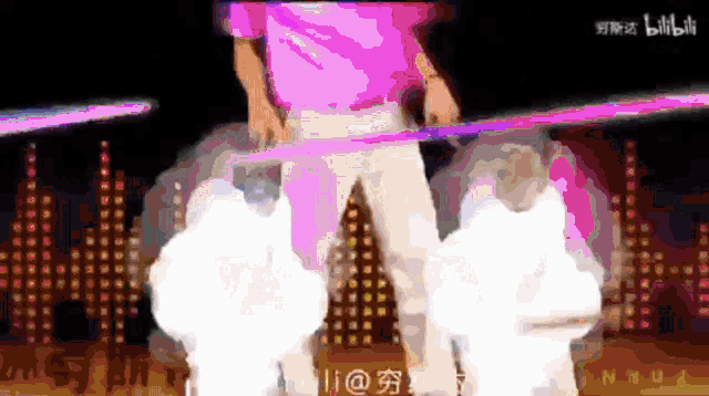 a man in a pink shirt is holding a purple object
