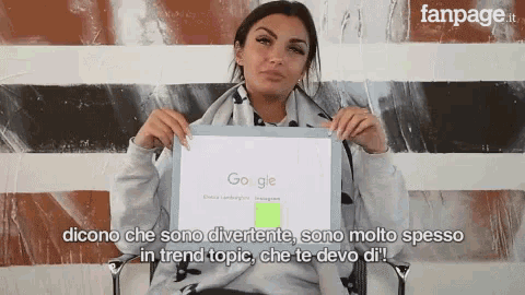 a woman is holding up a sign that says " google "