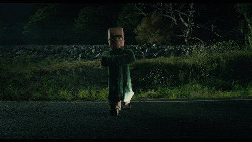 a person is jumping in the air near a car at night