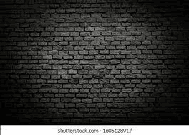 a black brick wall with a glowing effect in the dark