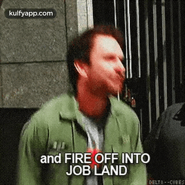 a man in a green jacket is saying `` and fire off into job land '' while standing in front of a building .