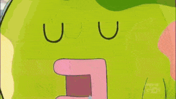 a green cartoon character with a pink heart on its chest is sleeping next to a white cat .