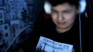 a young man wearing headphones and a shirt that says feel rhythm of the city