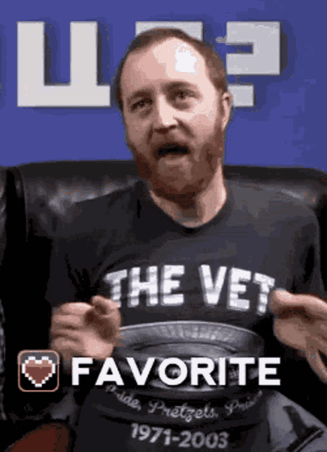 a man with a beard is wearing a black shirt that says the vet