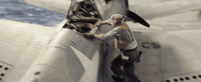 a man is working on a plane with the letters cs on it