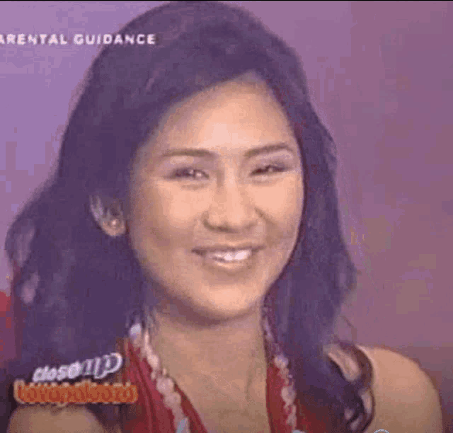 a close up of a woman 's face with a purple background and the words `` parental guidance '' on the bottom .