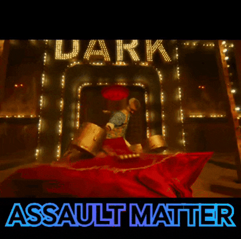 a man standing in front of a sign that says dark assault matter